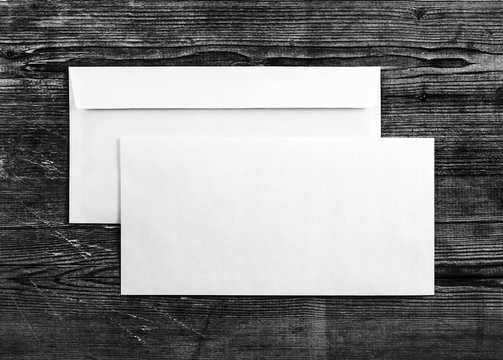 Blank envelopes on wooden background. Two envelopes. Back and front view. Mock-up for your design. For design portfolios. Top view.