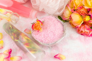 Red and yellow roses with massage oil and bath salt