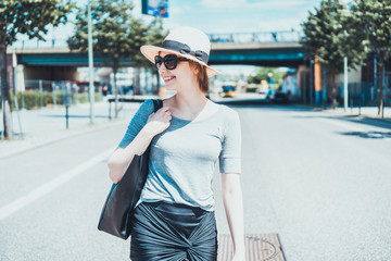 Smiling happy young woman walking in a street