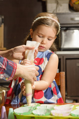 Little Girl Baking Cookies. Beautiful daughter helping her mother to prepare muffins