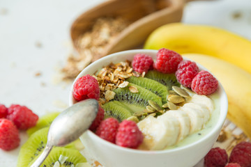 Smoothie in a bowl with fruits and seeds