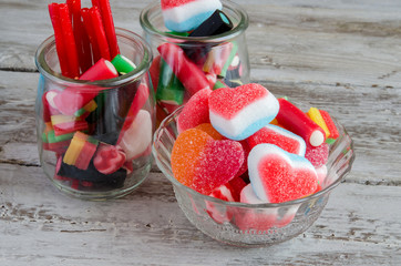 Assortment of sweets and candies in bowls on table