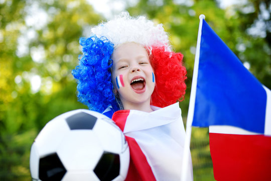Funny little girl supporting and cheering her national football team
