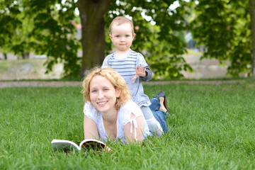 Beautiful young woman with her baby in the park.