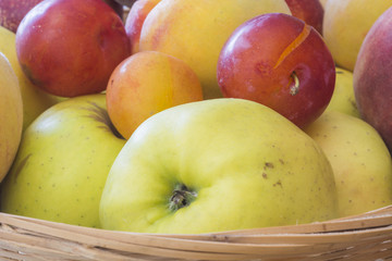 close up of fresh seasonal fruit , with apples and peaches