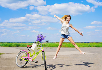 Young cheerful girl jumping on beautiful sky background