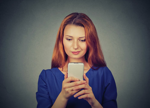 angry woman unhappy, annoyed by something on cell phone texting receiving bad sms message