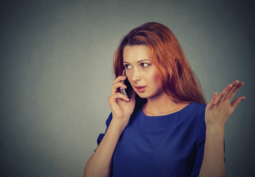 upset sad, unhappy, serious woman talking on phone displeased with conversation
