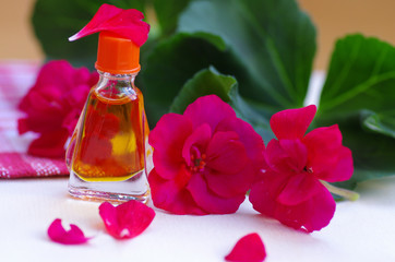 Essential geranium oil on the wooden background