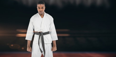 Naklejka premium Composite image of portrait of serious karate player
