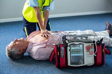 Paramedic using an external defibrillator