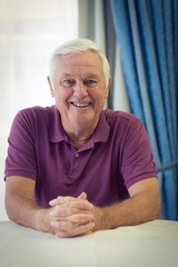 Portrait of senior man sitting in medical clinic