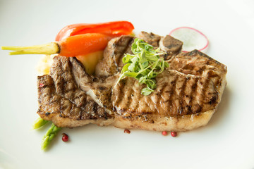  pork chop on a white plate