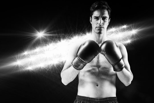 Composite image of portrait of boxer standing with boxing gloves