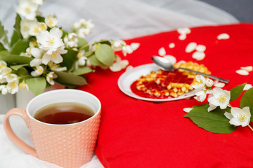 Breakfast in bed -tea and biscuits with strawberry jam