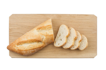 White small bread being cut on wooden board