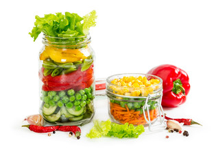 Colorful vegetables in glass jars