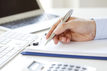 Fill the form. Close-up image of a businessman's hands initialing some paperwork.