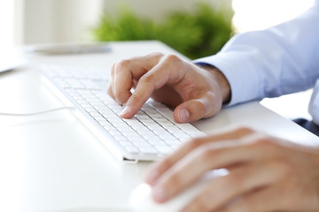 Typing on keyboard. Close-up image of hands working on a computer keyboard.