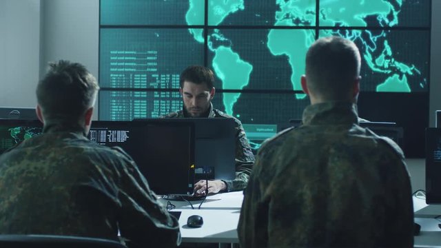 Group of Military IT Professionals in Monitoring Room Filled with Displays on Military Base. Shot on RED Cinema Camera in 4K (UHD).