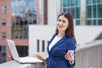 Beautiful young business woman calling by phone