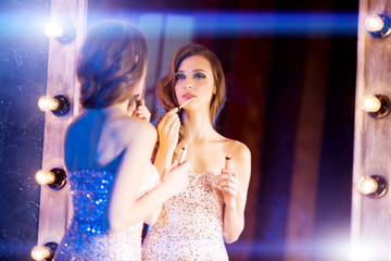 Young beautiful girl in the mirror in a nightclub. Beauty woman.