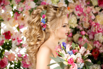 Wedding hairstyle a young girl. Bride. Woman with Flowers in her