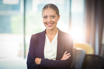 Businesswoman standing with arms crossed in the office