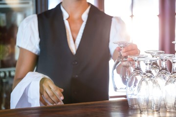 Waitress cleaning glasses