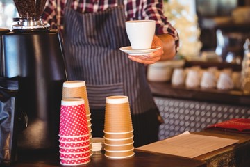 Waiter handing over a coffee