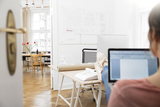 Woman using laptop in office