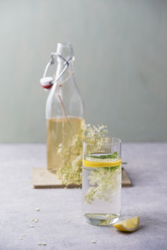 Glass of water flavoured with elderflower sirup and lemon
