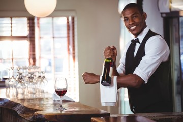 Portrait of bartender holding a wine bottle 