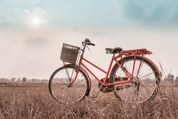 Naklejka na ściany i meble beautiful landscape image with Bicycle at sunset ; vintage filte