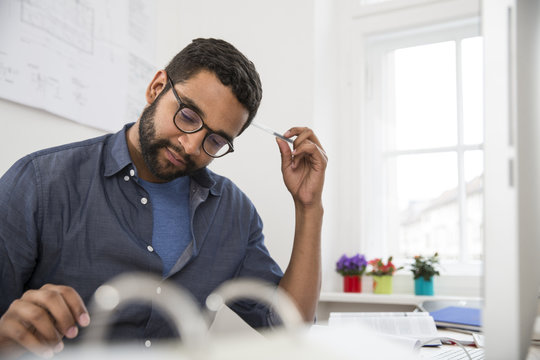 Young man working at desk in office