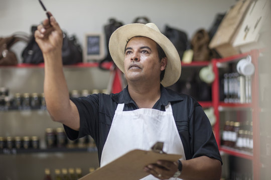 Shopkeeper in shop counting stock