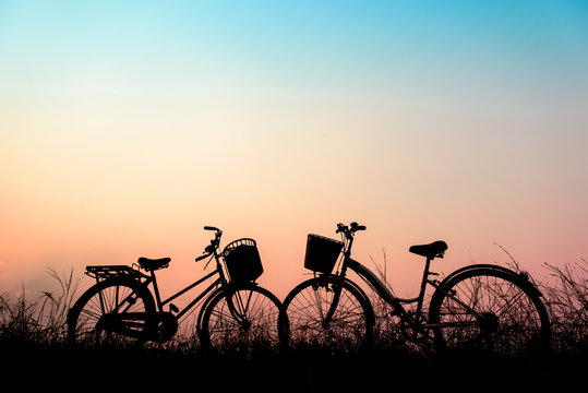 beautiful landscape image with Silhouette vintage bicycle at sun