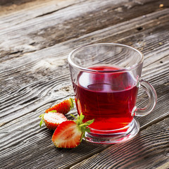 Health drink. Summer Fruit tea with fresh strawberries and garden barberry in glass