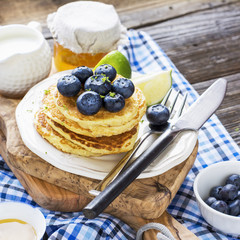 Healthy breakfast classic. Several domestic hot pancakes with fresh ripe blueberry lime zest, honey