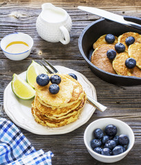 Healthy breakfast classic. Several domestic hot pancakes with fresh ripe blueberry lime zest, honey
