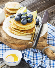 Healthy breakfast classic. Several domestic hot pancakes with fresh ripe blueberry lime zest, honey