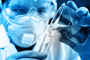 Hands of clinician holding tools during scientific experiment in