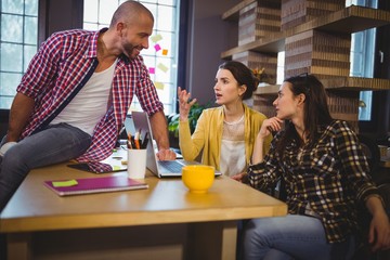 Creative business people discussing at desk