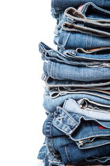 stack of jeans on white background