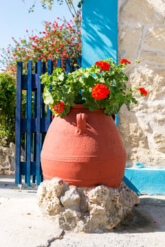 Geranium in a big pottery amphora. Big flower pot in the streets of Pitsidia, a the small town in the south central of Crete. Geraniums are often used as an ornamental plant on terraces and balconies