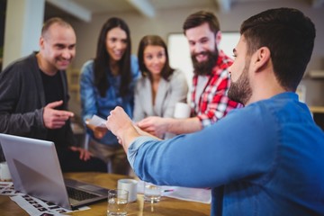 Businessman giving documents to colleagues