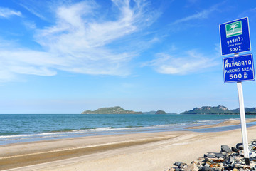 Fototapeta premium Coastal asphalt road with the bicycle lane and cloudy blue sky at Hua Hin, Southern Thailand.