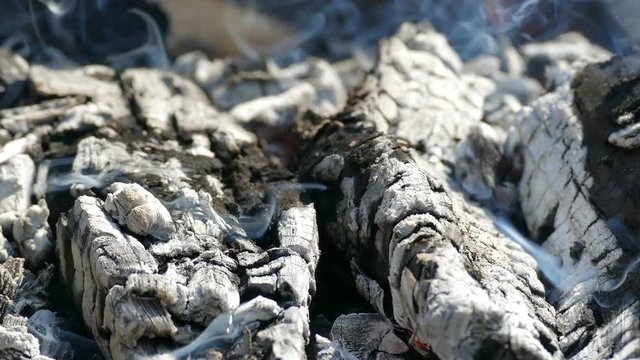 flame burning charcoal emits smoke