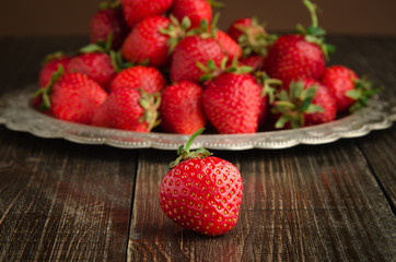 fresh strawberries on vitage plate, wooden background front view