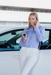 Beautiful young woman with car